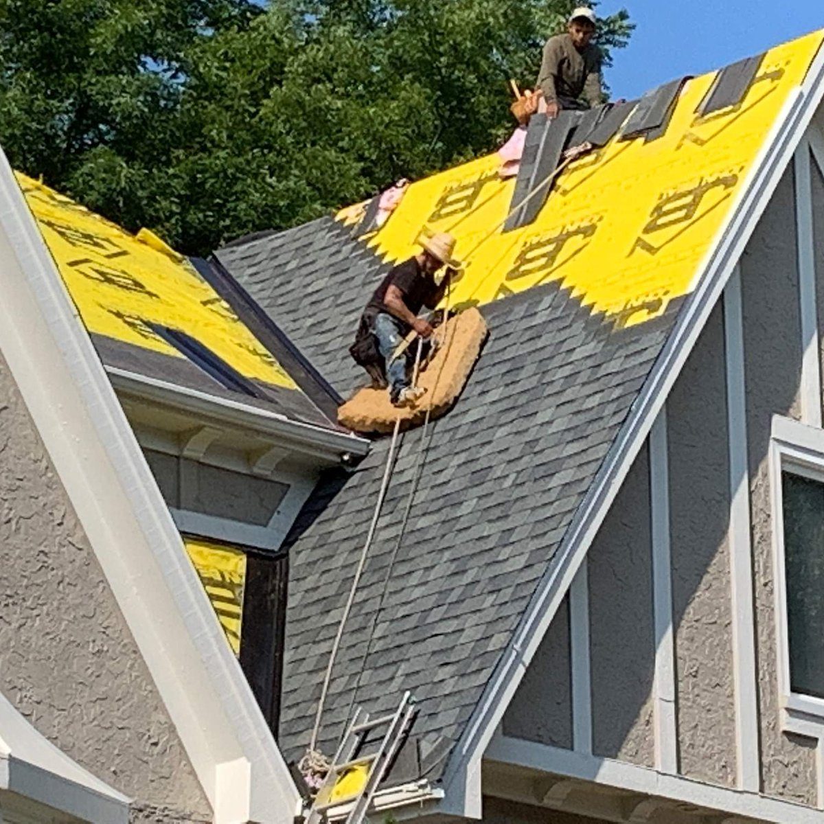 John Beal Roofing crew and branded truck at a St. Louis roof repair job site